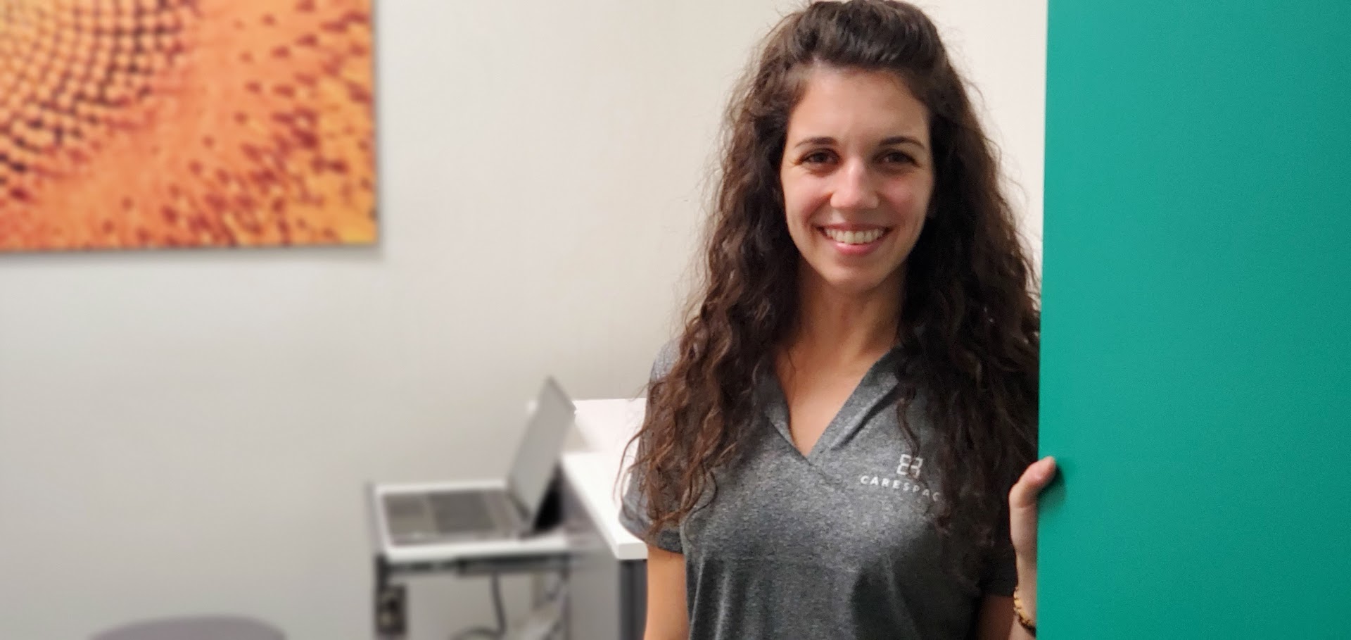 smiling female kitchener chiropractor standing in doorway