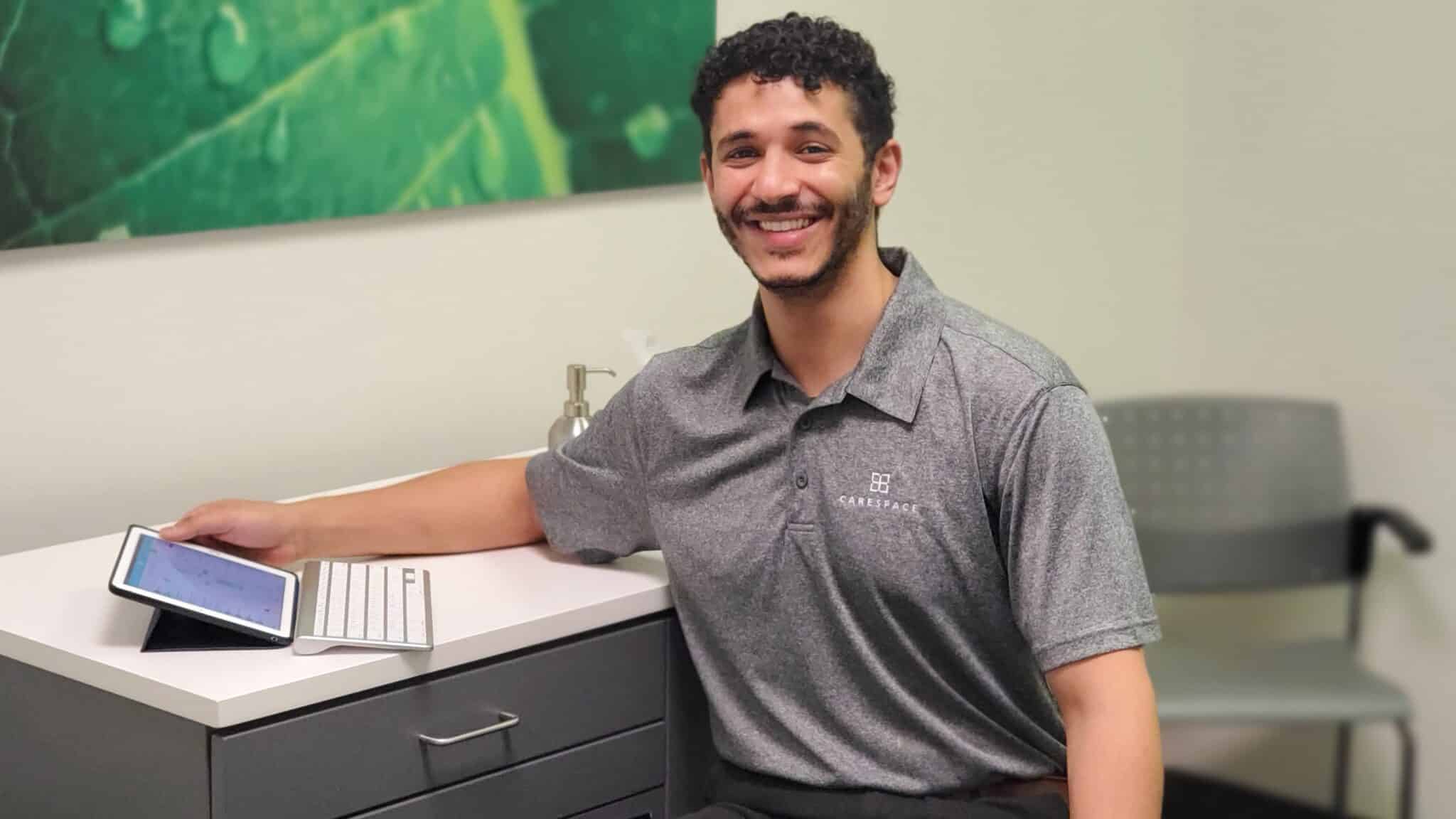 waterloo chiropractor sitting at desk at carespace