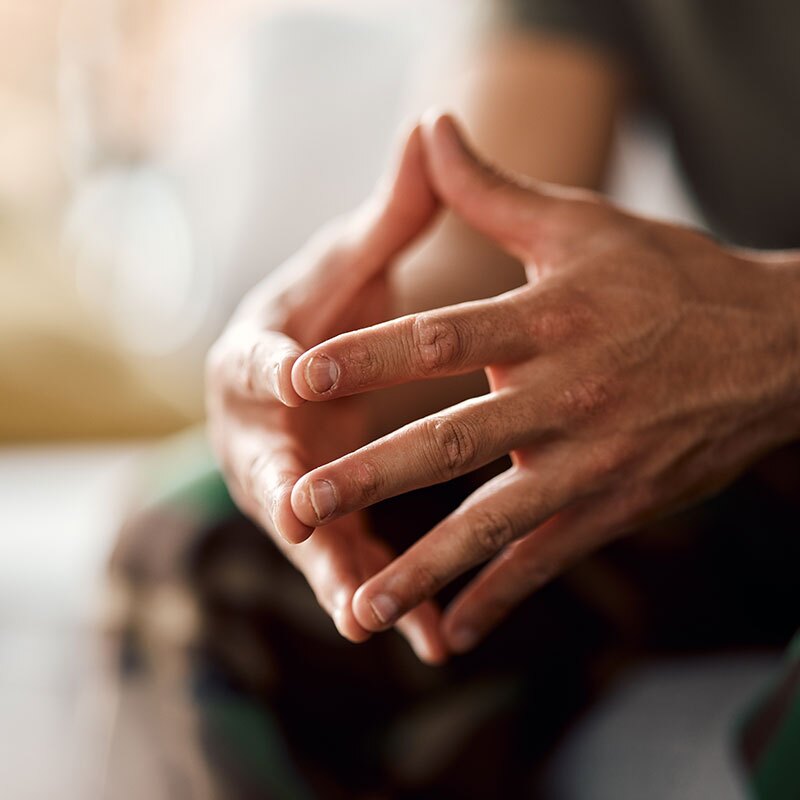 man sitting showing signs of ptsd