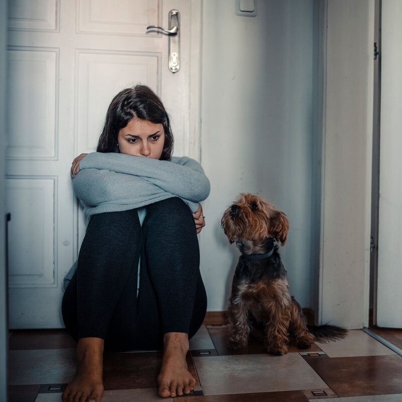 young woman with mental disorders sitting with her dog