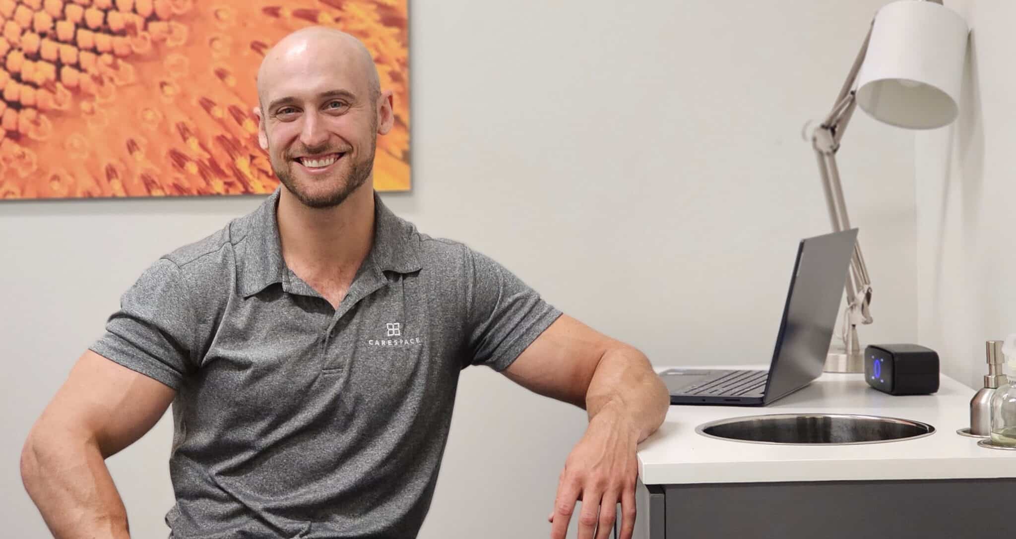 a Chiropractor sitting in treatment room at CARESPACE