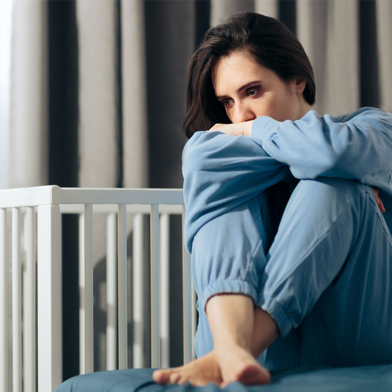 woman struggling alone with postpartum depression