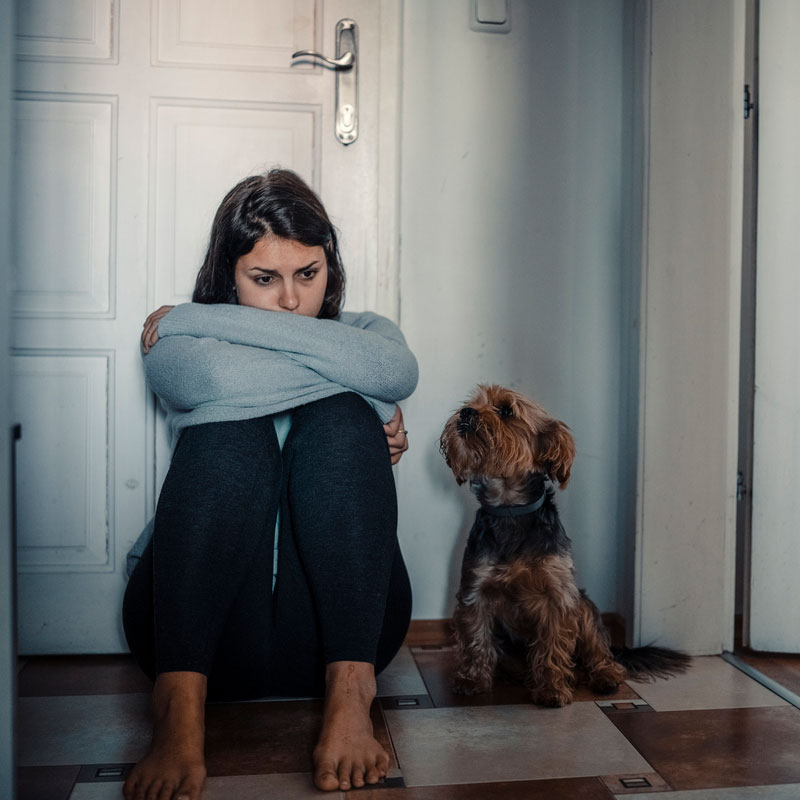 young woman with mental disorders sitting with her dog