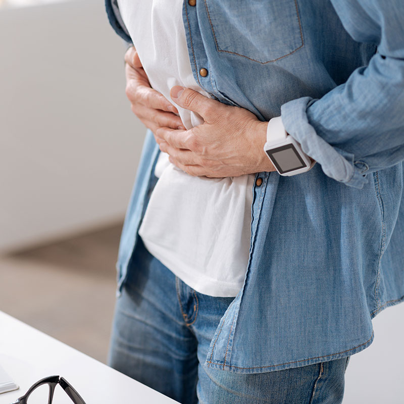 man with stomach cramps from gastrointestinal issues