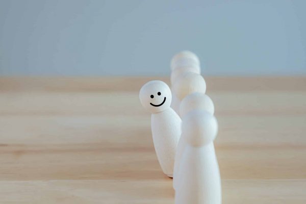 Individuality. Unique. Happy and enjoy stand out from group. Smiling figure among many crowd. Human development. Psychology Personality Concept.